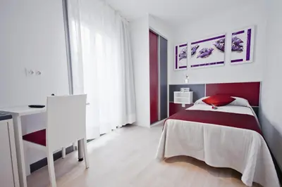 a bedroom with a bed and a desk in it at Hotel Ferramenteiro de Portomarin in Portomarin