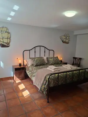 a bedroom with a bed and a table and lamps at As Pitas 4B in Tapia de Casariego