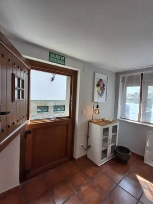 a room with a door and a window and a table at As Pitas 4B in Tapia de Casariego