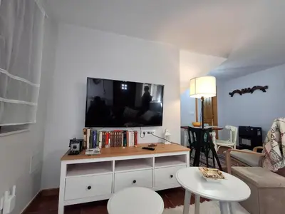 a living room with a tv on a wall at As Pitas 4B in Tapia de Casariego
