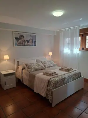 a bedroom with a bed with two people on it at As Pitas 4B in Tapia de Casariego