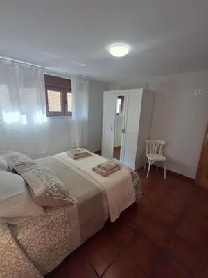 a bedroom with a bed and a chair in it at As Pitas 4B in Tapia de Casariego