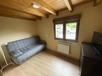 a living room with a couch and a window at Apartamentos Rurales Casa Carloto