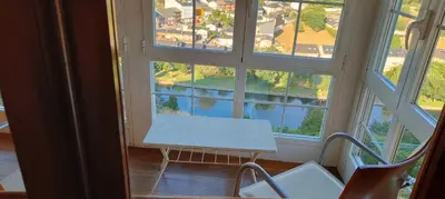 a window with a bench in a room with a view at VUT 85 Teclas in Puebla de Sanabria