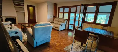 a living room with a couch and chairs and a piano at VUT 85 Teclas in Puebla de Sanabria