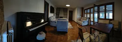 a living room with a piano and a table and chairs at VUT 85 Teclas in Puebla de Sanabria