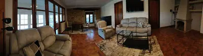a living room with a couch and chairs and a fireplace at VUT 85 Teclas in Puebla de Sanabria