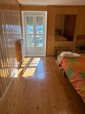 a bedroom with a bed and a window and a door at VUT 85 Teclas in Puebla de Sanabria