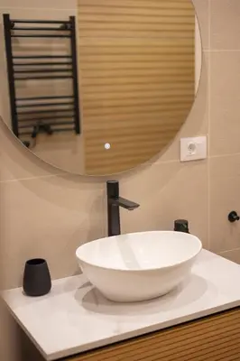 a bathroom with a white sink and a mirror at Luz Marina in Ribadeo