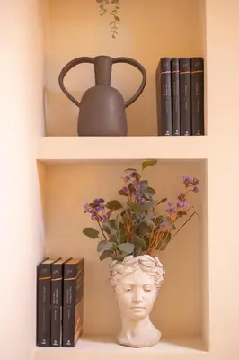 a book shelf with a vase with a plant in it at Luz Marina in Ribadeo