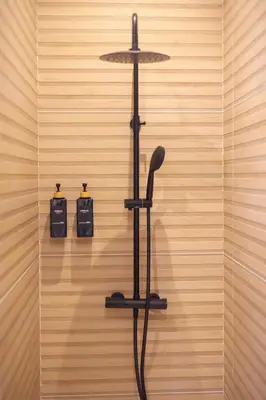 a black hair dryer hanging on a wall at Luz Marina in Ribadeo