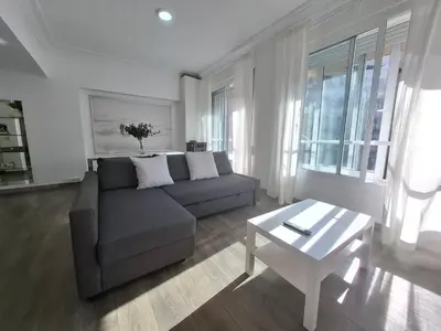 a living room with a couch and a table at Disfruta de las vistas al Parque de San Lazaro in Ourense