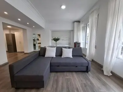 a living room with a large gray couch in a room at Disfruta de las vistas al Parque de San Lazaro in Ourense