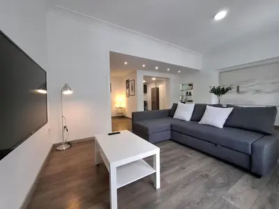 a living room with a couch and a table at Disfruta de las vistas al Parque de San Lazaro in Ourense