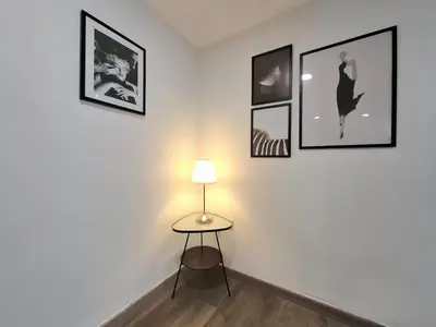 a room with a table and pictures on the wall at Disfruta de las vistas al Parque de San Lazaro in Ourense