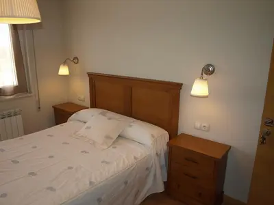 a small bedroom with a bed and two night stands at Casa Melva in Barreiros