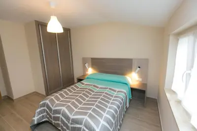a bedroom with a bed in a room with a window at Casa Melva in Barreiros