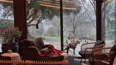 a living room with chairs and a large window at Galician Stone House Santiago in Ramallosa