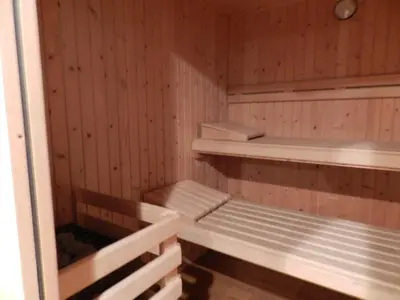 a sauna with wooden walls and shelves in it at Parador de Vilalba in Villalba