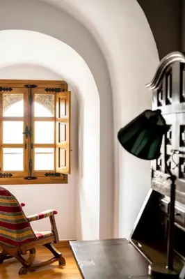 a room with a desk and a chair and a window at Parador de Vilalba in Villalba