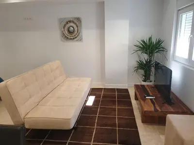a living room with a couch and a table at XELIÑA e in A Estrada
