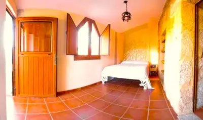 a room with a bench in the middle of a room at A Casa do Aloumiño da Auga Mondariz VT-PO-00148 y SPA Prexigueiro Obsequio entrada por persona a circuito termal in San Félix