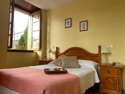 a bedroom with a bed with a tray on it at Ahío San Martín, Apartamentos Rurales Casa de la Villa in San Martín de Oscos