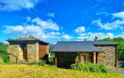 a small stone house on top of a hill at 39A01 La Casita Olga Casa en plena naturaleza by R2R Consulting in Arrojo