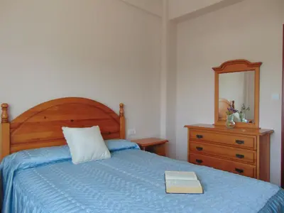 a bedroom with a bed with a book on it at Casa Esperanza 8 huéspedes