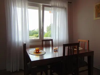a dining room table with chairs and a window at Casa Esperanza 8 huéspedes