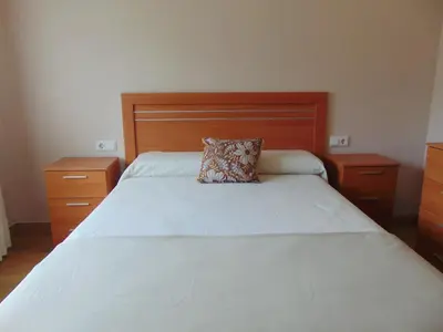 a bedroom with a bed with a pillow on it at Casa Esperanza 8 huéspedes