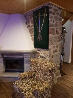 a couch sitting in front of a stone fireplace at Buleiro in Ourense