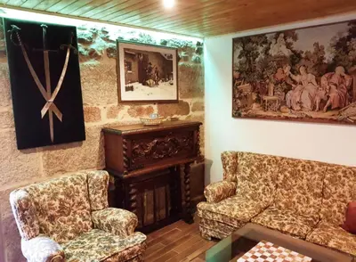 a living room with two chairs and a painting on the wall at Buleiro in Ourense