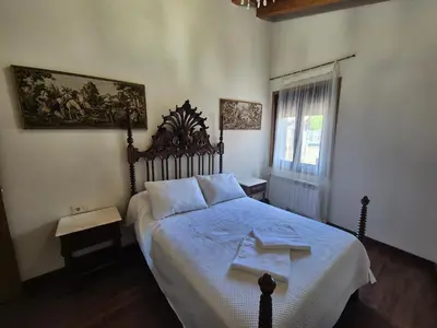 a bedroom with a large bed with blue sheets at Buleiro in Ourense