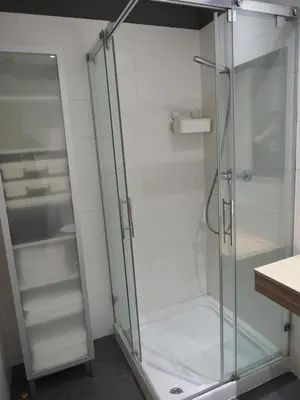 a shower with a glass door in a bathroom at Rúa Mariñeiro in Burela de Cabo
