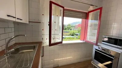 a kitchen with a sink and a window in it at Apartamento céntrico in Burela de Cabo