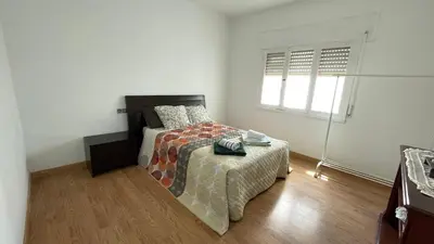 a bedroom with a bed and a window at Apartamento céntrico in Burela de Cabo