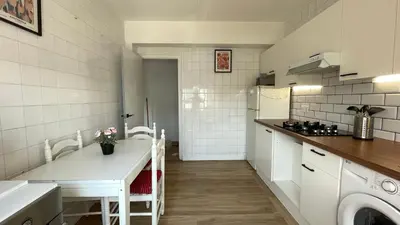 a kitchen with a sink and a table in a room at Apartamento céntrico in Burela de Cabo