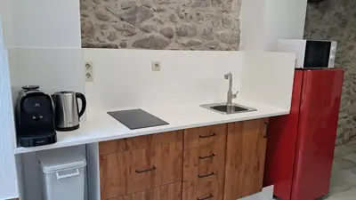 a small kitchen with a sink and a red refrigerator at Casa Loma Lola in Molinaseca