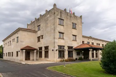 a large stone building with a flag on top of it at Parador de Verín in Monterrei