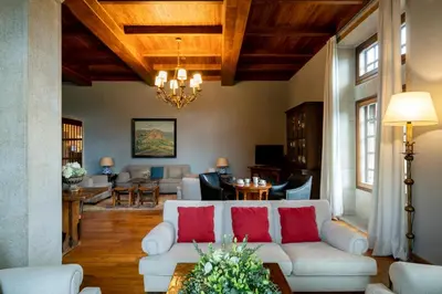 a living room with a white couch and red pillows at Parador de Verín in Monterrei