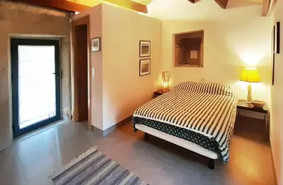a bedroom with a large bed and a window at Pension Do Picho