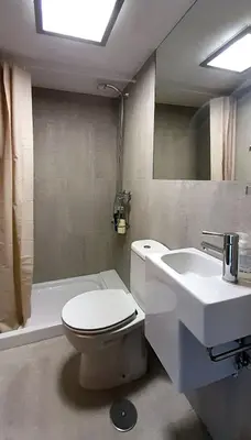 a bathroom with a white toilet and a sink at Pension Do Picho