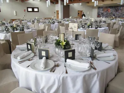 a table set up for a wedding with white table settings at Parador de Villafranca del Bierzo in Villafranca del Bierzo