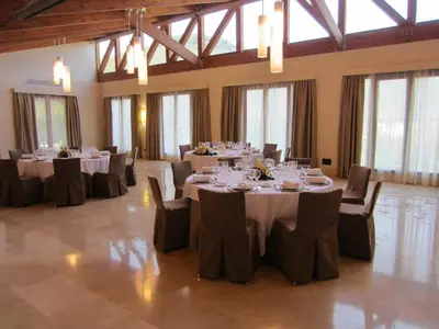 a banquet hall with tables and chairs with white tablecloths at Parador de Villafranca del Bierzo in Villafranca del Bierzo
