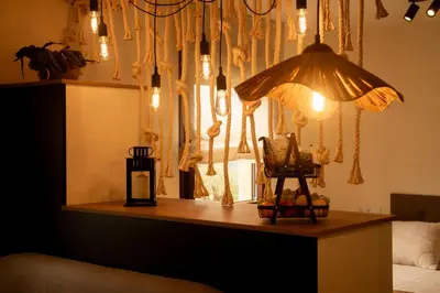 a room with a table with a lamp and a window at Apartamentos turísticos en la naturaleza in Barreiros