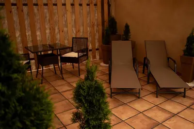 a patio with chairs and a table and a table and chairs at Apartamentos turísticos en la naturaleza in Barreiros