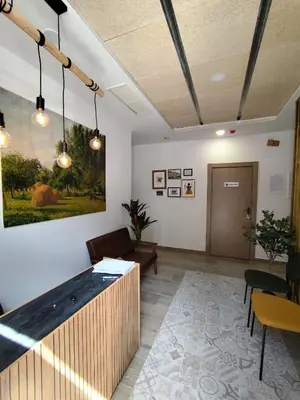 an office lobby with a large painting on the wall at Hotel Casa dos Gardas in Samos