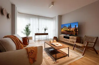 a living room with a couch and a tv at Vita Homes by Upper Luxury Housing in Santiago de Compostela