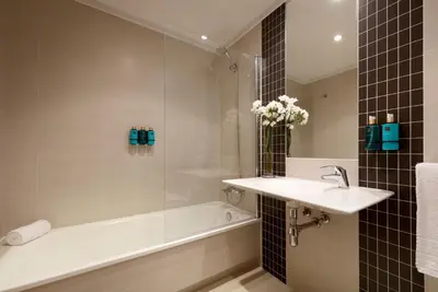 a bathroom with a bath tub and a sink and a bath tubermott at Vita Homes by Upper Luxury Housing in Santiago de Compostela